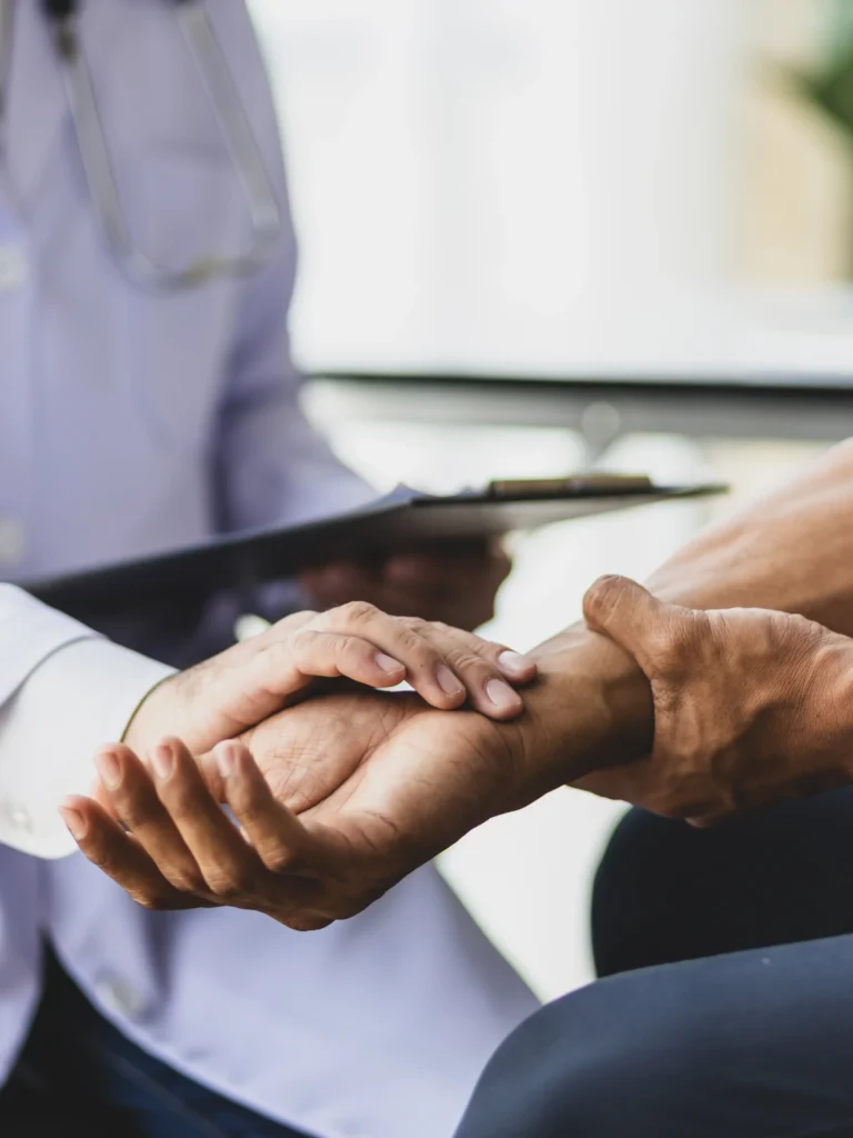 Physician assessing patient pain in wrist